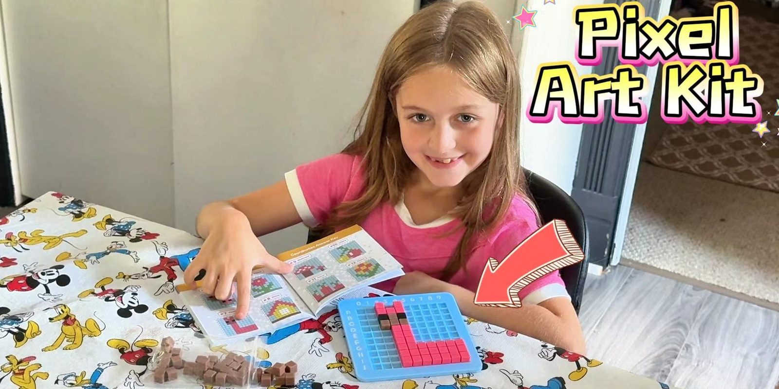 Girl building a picture on the CYOEST pixel art STEM kit