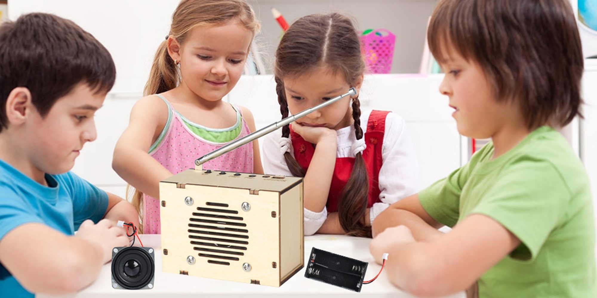 Children building a CYOEST DIY FM radio kit at a classroom table